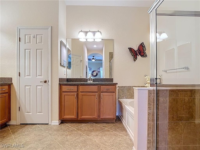 13885 Cleto Dr, Estero, FL 33928 - bathroom with tile patterned floors, a shower stall, vanity, and a garden tub