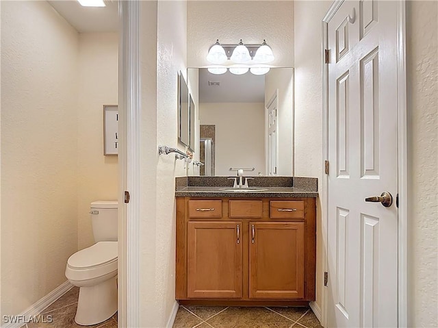 13885 Cleto Dr, Estero, FL 33928 - bathroom with a textured wall, tile patterned floors, vanity, and toilet