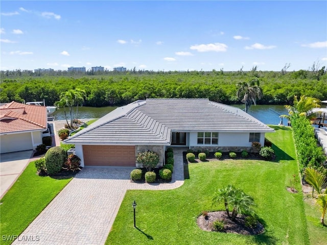 14701 Eden St, Fort Myers, FL 33908 - view of front of home featuring a front lawn, driveway, stone siding, a garage, and stucco siding