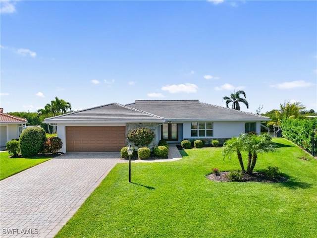 14701 Eden St, Fort Myers, FL 33908 - single story home featuring stucco siding, an attached garage, decorative driveway, and a front yard