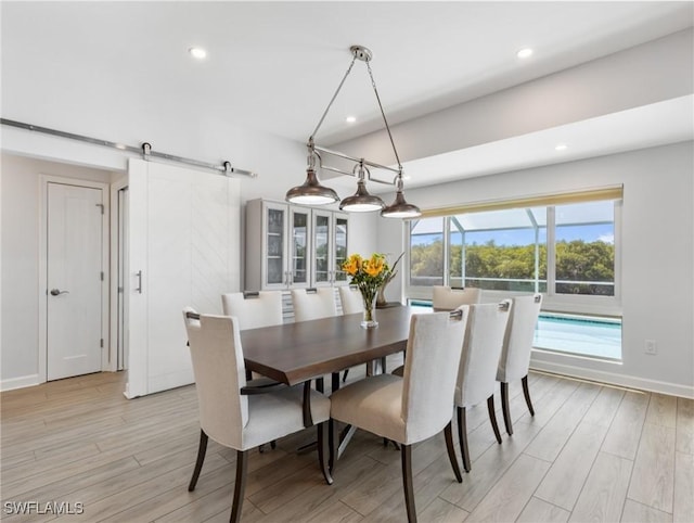 14701 Eden St, Fort Myers, FL 33908 - dining area featuring a barn door, recessed lighting, baseboards, and light wood-style flooring