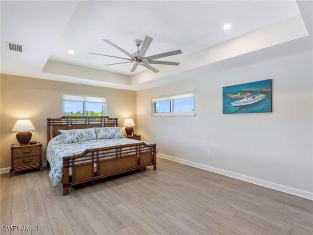 14701 Eden St, Fort Myers, FL 33908 - bedroom with baseboards, visible vents, recessed lighting, light wood-style floors, and a raised ceiling