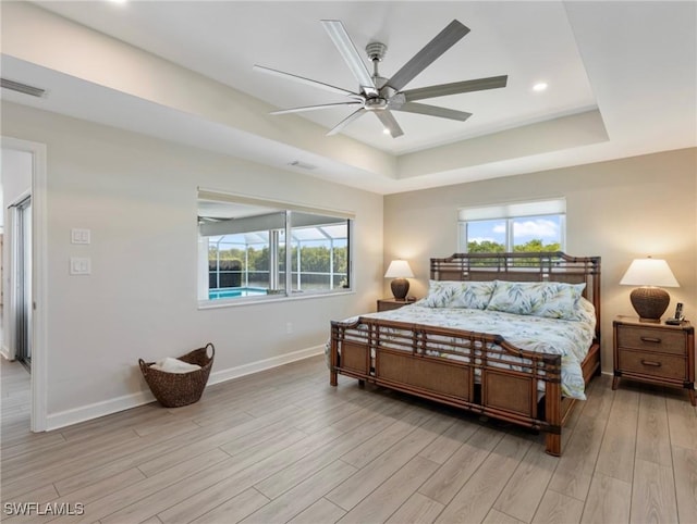 14701 Eden St, Fort Myers, FL 33908 - bedroom with light wood-style flooring, a tray ceiling, baseboards, visible vents, and recessed lighting