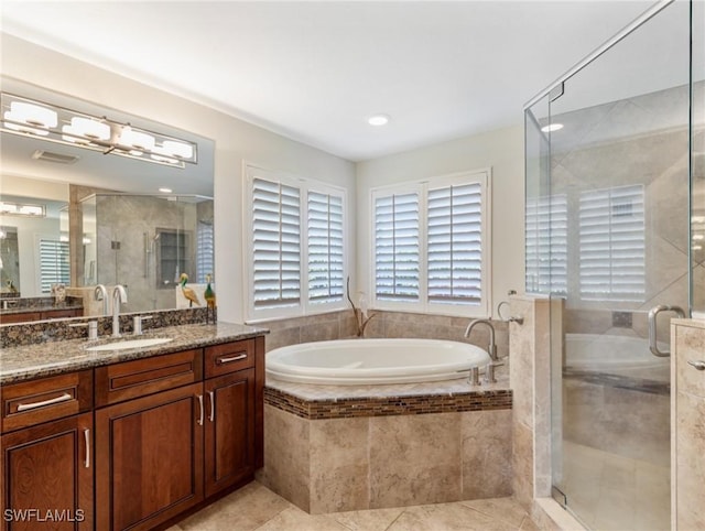 14701 Eden St, Fort Myers, FL 33908 - full bath featuring a garden tub, tile patterned flooring, vanity, and a stall shower