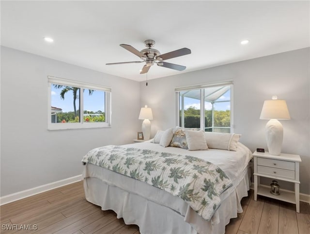 14701 Eden St, Fort Myers, FL 33908 - bedroom featuring light wood finished floors, baseboards, recessed lighting, and multiple windows