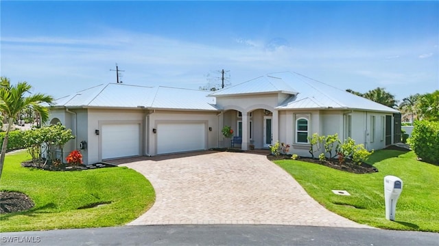 single story home with an attached garage, a front lawn, stucco siding, decorative driveway, and metal roof
