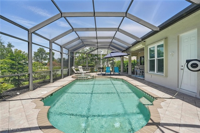 view of pool with glass enclosure, a patio, and a pool with connected hot tub