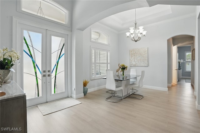 entryway featuring crown molding, arched walkways, and french doors