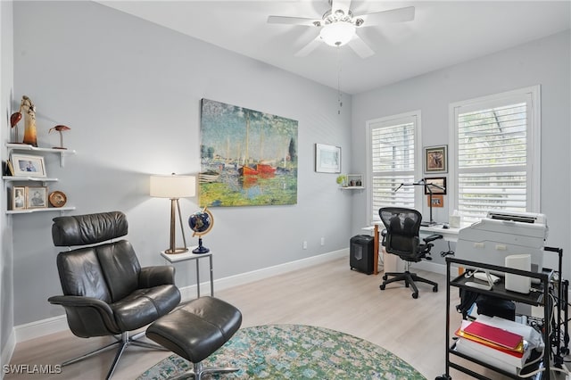 home office featuring baseboards, a ceiling fan, and wood finished floors