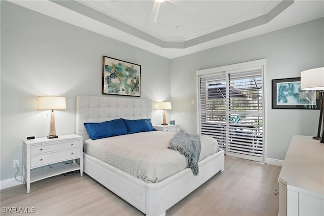 bedroom featuring crown molding, baseboards, light wood-type flooring, and access to exterior
