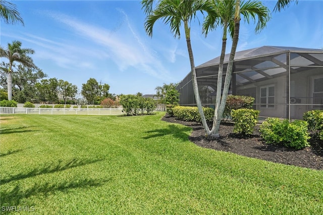 view of yard with a lanai and fence