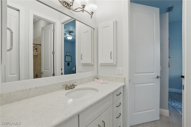 full bathroom with vanity, a shower, and visible vents