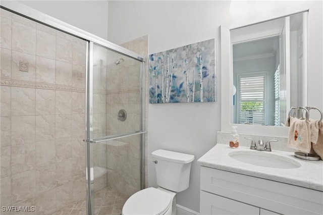 full bathroom with vanity, a shower stall, and toilet