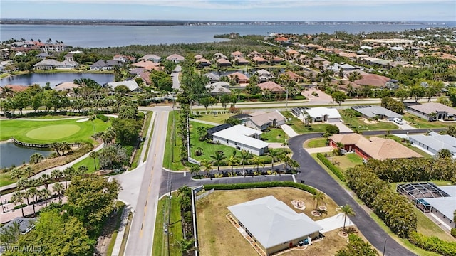aerial view featuring a residential view, a water view, and golf course view