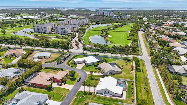birds eye view of property with a residential view, view of golf course, and a water view