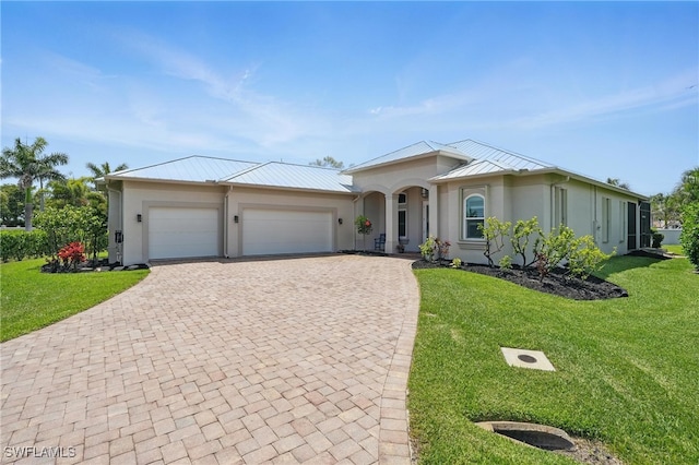 view of front facade with an attached garage, decorative driveway, a front lawn, and stucco siding