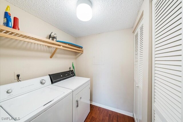 64 4th St Unit B208, Bonita Springs, FL 34134 - laundry area with washing machine and clothes dryer, a textured ceiling, baseboards, dark wood-style flooring, and laundry area