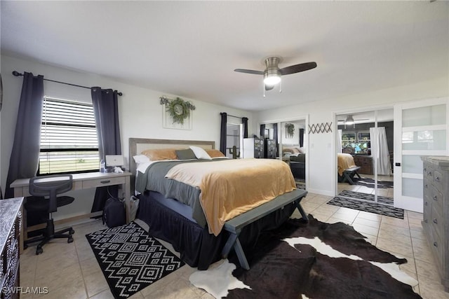 bedroom featuring two closets, light tile patterned floors, and ceiling fan