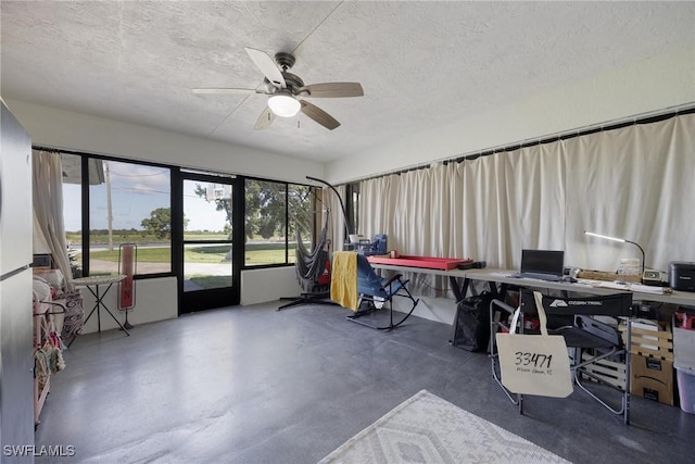 office area featuring a textured ceiling, concrete floors, and ceiling fan