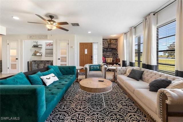 living room featuring a ceiling fan, visible vents, and recessed lighting