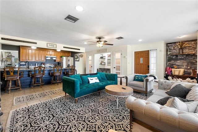 living room featuring visible vents, a ceiling fan, light tile patterned flooring, and recessed lighting