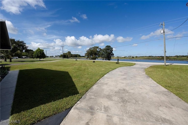 view of property's community with a lawn