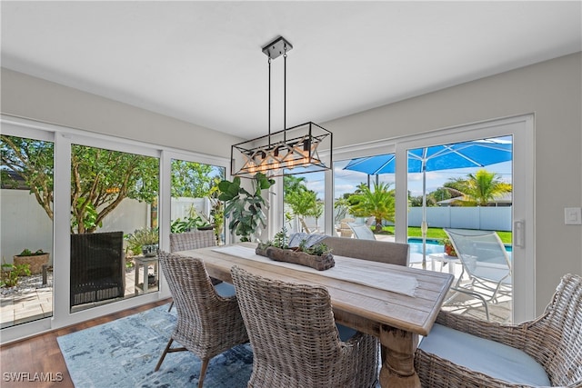 dining area with an inviting chandelier and wood finished floors