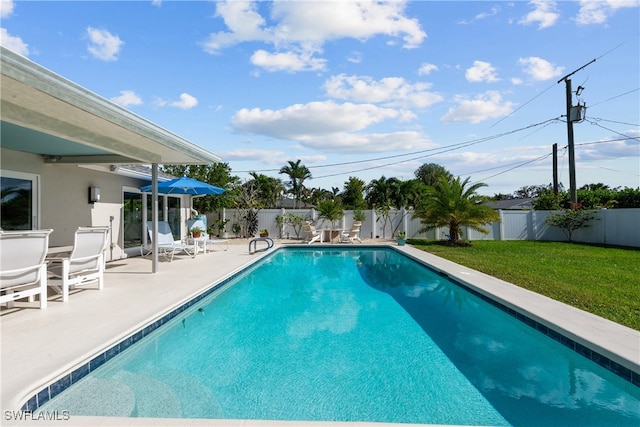 view of swimming pool featuring a fenced in pool, a patio area, a fenced backyard, and a yard