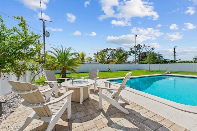 view of swimming pool featuring a fire pit, a yard, a fenced backyard, a patio, and a fenced in pool