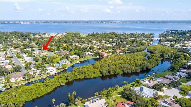 bird's eye view featuring a water view and a residential view