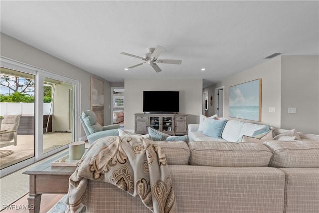 living area featuring visible vents, a ceiling fan, and recessed lighting