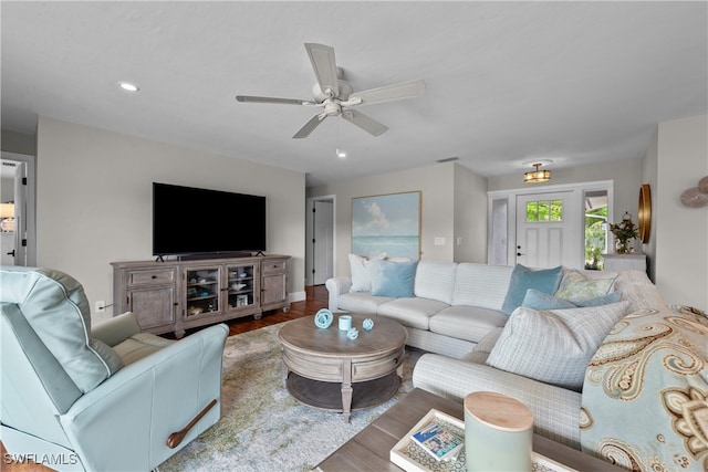 living area with recessed lighting, a ceiling fan, wood finished floors, and baseboards
