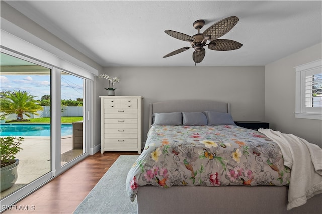 bedroom with access to outside, ceiling fan, and dark wood finished floors