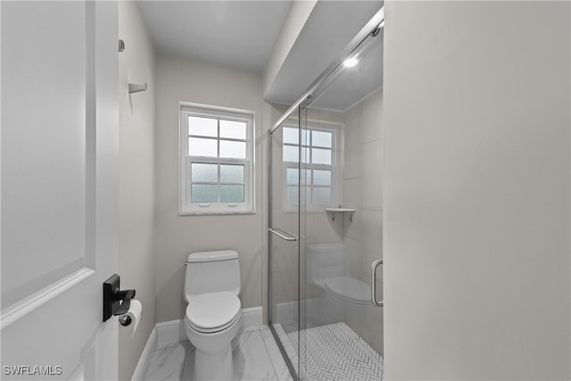 bathroom featuring toilet, marble finish floor, baseboards, and a shower stall