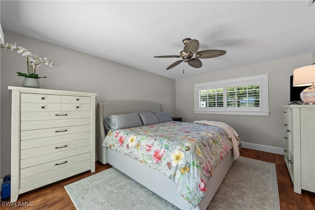 bedroom featuring ceiling fan, baseboards, and dark wood finished floors