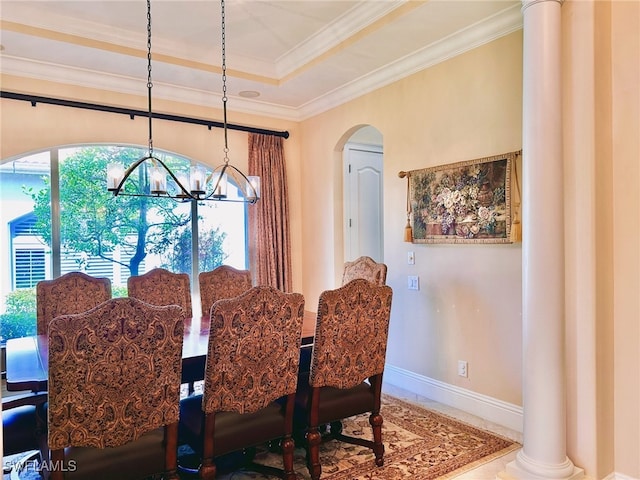 12125 Via Cercina Dr, Bonita Springs, FL 34135 - dining area featuring crown molding, arched walkways, an inviting chandelier, a raised ceiling, and baseboards