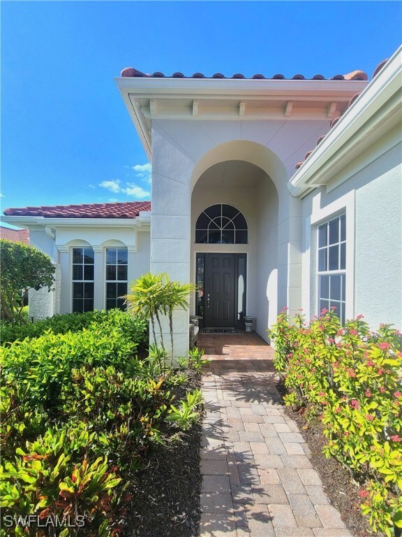 12125 Via Cercina Dr, Bonita Springs, FL 34135 - doorway to property with stucco siding