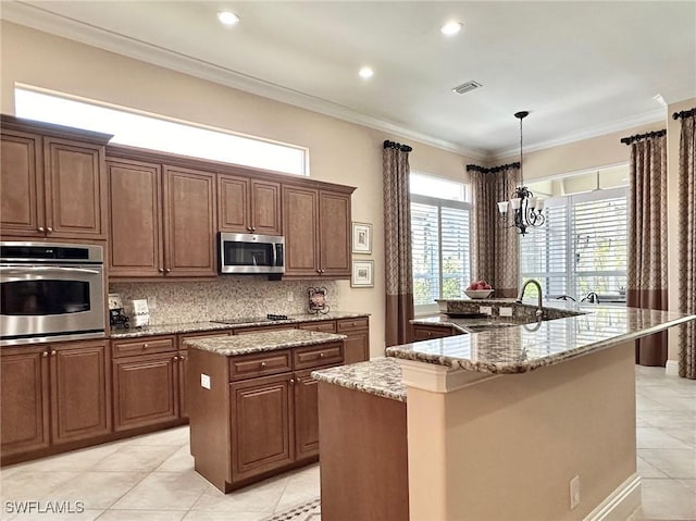 12125 Via Cercina Dr, Bonita Springs, FL 34135 - kitchen with stainless steel appliances, a sink, a spacious island, visible vents, and light tile patterned floors