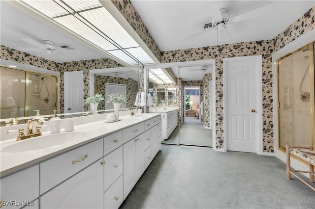 3098 Greenflower Ct, Bonita Springs, FL 34134 - bathroom with wallpapered walls, ceiling fan, a shower stall, double vanity, and baseboards