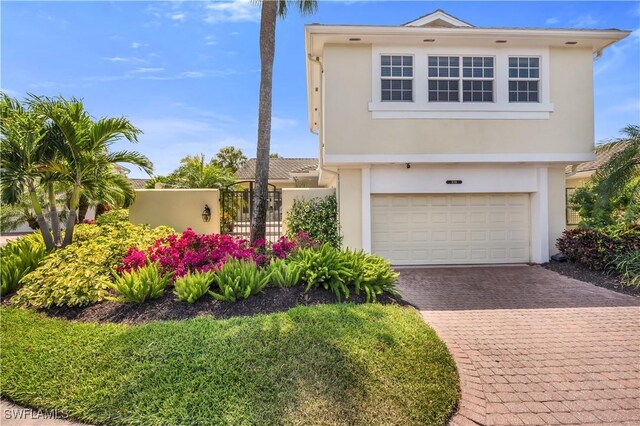 3098 Greenflower Ct, Bonita Springs, FL 34134 - view of front facade with stucco siding, an attached garage, and decorative driveway