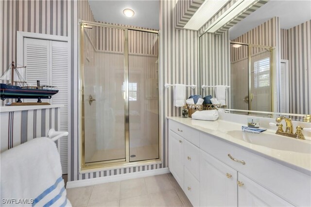 3098 Greenflower Ct, Bonita Springs, FL 34134 - full bath with wallpapered walls, a shower stall, vanity, and tile patterned floors