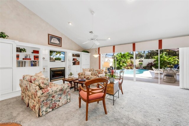3098 Greenflower Ct, Bonita Springs, FL 34134 - living room featuring a glass covered fireplace, light carpet, a ceiling fan, high vaulted ceiling, and recessed lighting