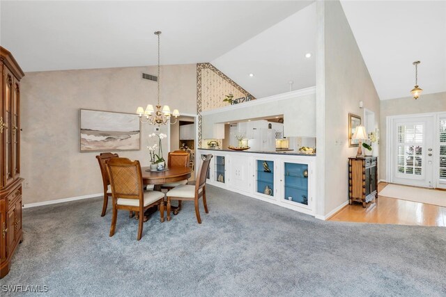 3098 Greenflower Ct, Bonita Springs, FL 34134 - dining area with carpet floors, high vaulted ceiling, a chandelier, and baseboards