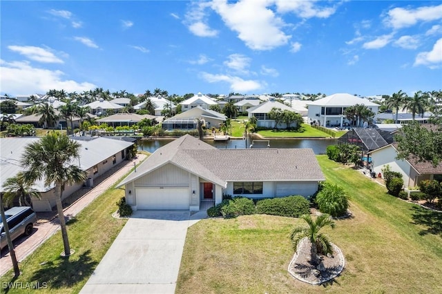 6181 Plumosa Ave, Fort Myers, FL 33908 - view of front of house with an attached garage, driveway, a front yard, and a water view