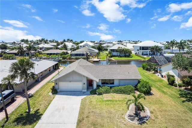 6181 Plumosa Ave, Fort Myers, FL 33908 - view of front of property with a front yard, a water view, a garage, a residential view, and driveway
