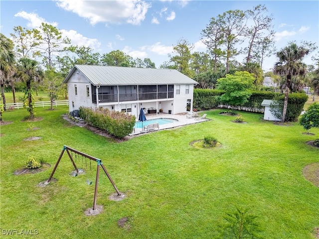 2920 24th Ave SE, Naples, FL 34117 - rear view of property featuring a yard, a sunroom, and a fenced backyard