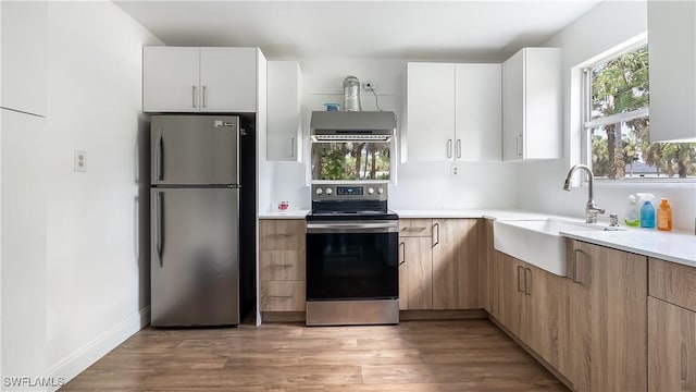 2920 24th Ave SE, Naples, FL 34117 - kitchen with stainless steel appliances, light countertops, a sink, and light wood-style floors