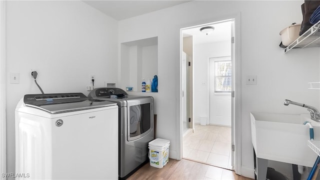 2920 24th Ave SE, Naples, FL 34117 - laundry room featuring laundry area, a sink, and washer and clothes dryer