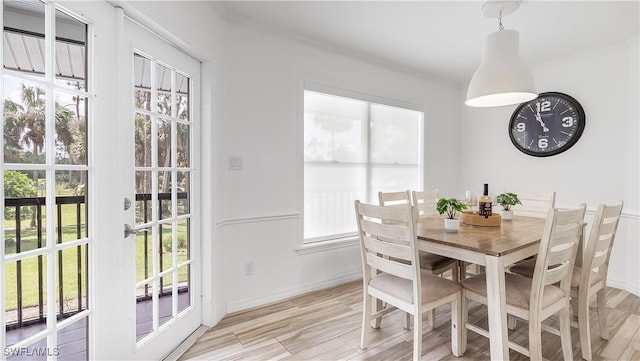 2920 24th Ave SE, Naples, FL 34117 - dining space featuring light wood-style floors, baseboards, and ornamental molding