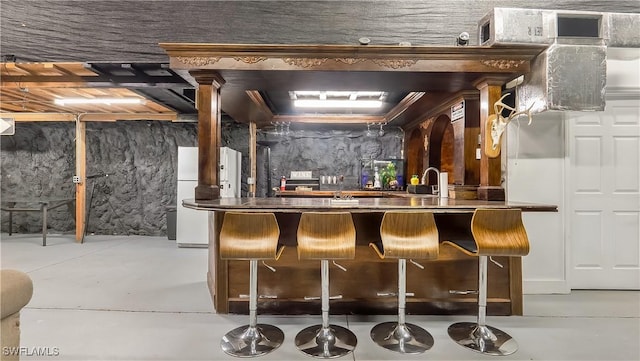 2920 24th Ave SE, Naples, FL 34117 - bar with concrete floors, a sink, and fridge